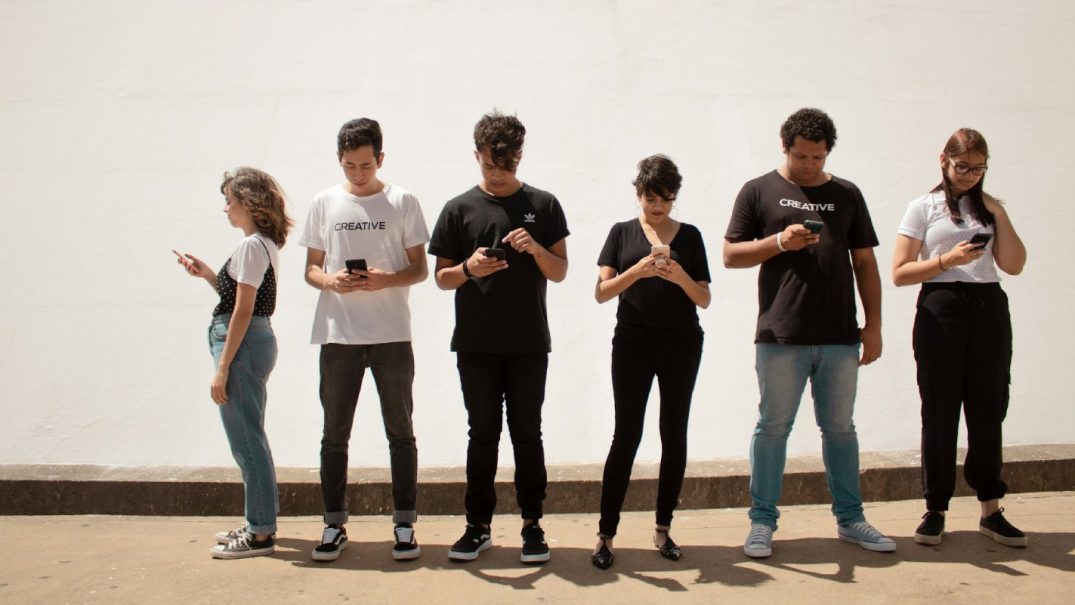teenagers ignoring each other on their phones at fitme wellness